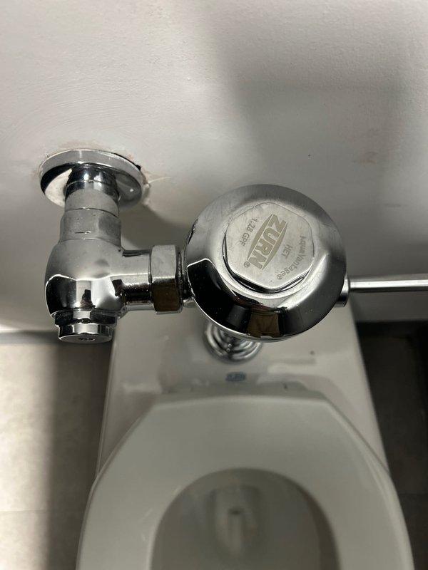 Responded to urgent plumbing issues at stadium facility, inspecting and servicing multiple water supply connections including braided stainless steel flex lines and associated valves. Repaired ZURN flush valve mechanism on commercial toilet fixture, replacing worn components to restore proper flushing operation.