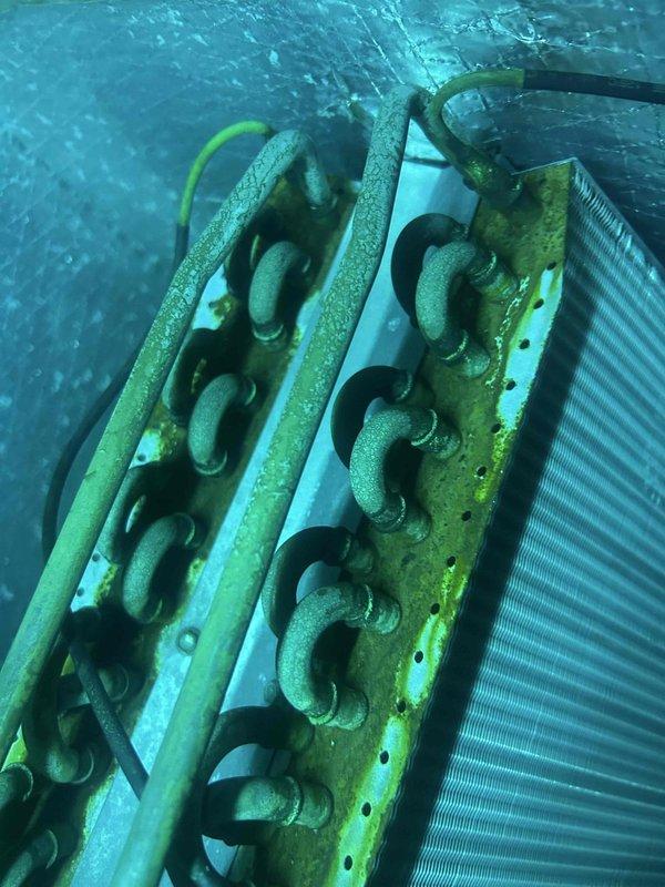 Responded to non-urgent service call for unit with suspected heat exchanger and blower issues. Upon inspection, discovered significant frost/condensation buildup on evaporator coil and evidence of corrosion or algae growth on metal surfaces. Examination of heat exchanger confirmed safety concerns with visible deterioration of metal coils and compromised structural integrity.