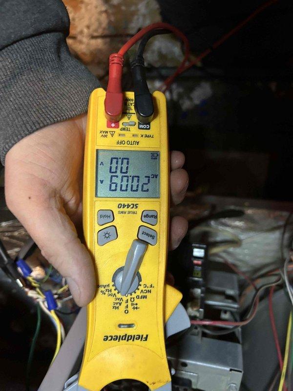 Performed comprehensive tune-up service on dual HVAC systems (20-year and 10-year units). Inspection revealed significant dust/debris accumulation and cobweb buildup around the MARS 30+3.0μF capacitor and electrical connections. Conducted electrical testing with Fieldpiece SC440 meter, verifying proper voltage readings of 600.2V across components to ensure system functionality.