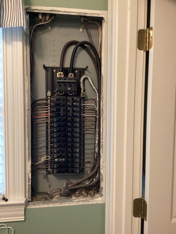 Conducted comprehensive assessment of existing electrical panel to determine compatibility for generator installation. Panel inspection revealed standard residential configuration with approximately 20 circuit breakers arranged in dual columns with main breaker at top. Customer also requested information regarding dehumidifier options for crawlspace, which was noted for inclusion in final quote.