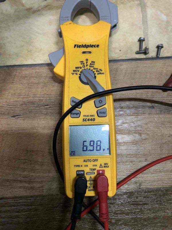 Performed annual Gold Level maintenance on 7-year-old HVAC system with CFI filter. Conducted electrical testing with clamp meter showing 6.98 amp reading. Inspected refrigerant lines and heat exchanger components, noting normal condensation on cooling coil.