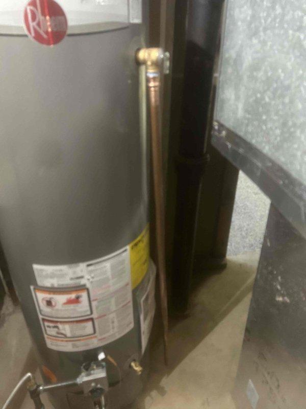 Successfully removed existing 40-gallon water heater and installed new Rheem 40-gallon unit with protective floor coverings maintained throughout service area. Installed 4" double-wall vent pipe properly routed to exterior of home, ensuring proper ventilation. All plumbing connections were secured and tested, old equipment was removed from premises, and work area was thoroughly cleaned upon completion.