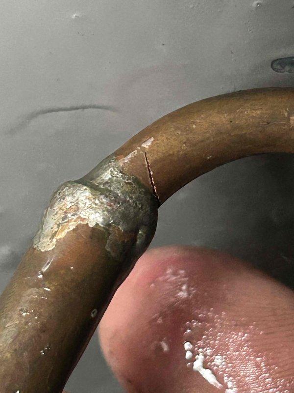 Diagnosed 3-year-old AC system with no cooling issue traced to significant corrosion at refrigerant line connections, causing refrigerant leakage and preventing proper system operation. Repaired corroded copper pipe joints, recharged system with appropriate refrigerant, and restored cooling functionality. Additionally, repaired collapsed ductwork under house to ensure proper airflow throughout the system.