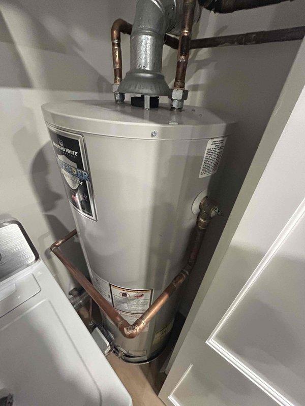 Inspected existing 50-gallon gas water heater installation and surrounding plumbing infrastructure. Provided customer with comprehensive quote for replacement unit of same specifications, scheduled for 1pm installation timeframe. Noted copper piping system in good condition with proper venting and connections intact.