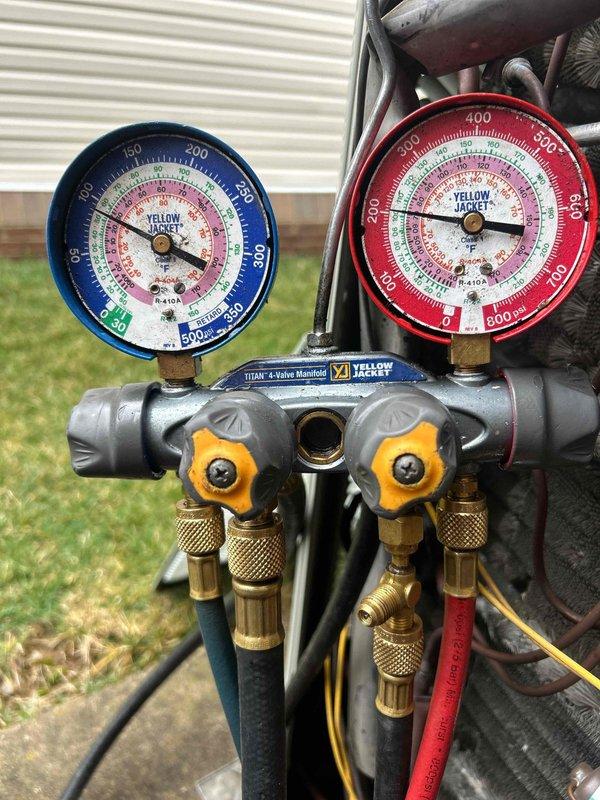 Responded to no-heat service call for 1-year-old electric HVAC system that wasn't maintaining adequate temperature for past two weeks. Performed diagnostic testing using Yellow Jacket 4-valve manifold gauge set to check refrigerant pressures. Discovered and corrected low refrigerant charge, which was preventing proper heat transfer in heating mode.
