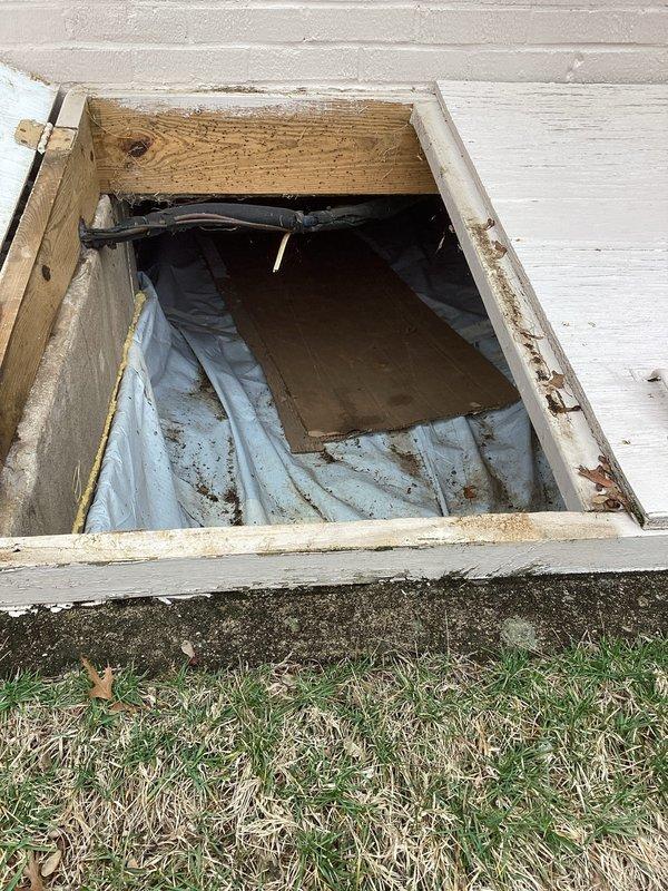 Conducted site assessment for generator installation, inspecting crawlspace access point for potential wiring pathways and evaluating existing electrical service panel configuration. Documented current meter setup and adjacent junction boxes to determine appropriate connection points and load capacity for proposed generator system.