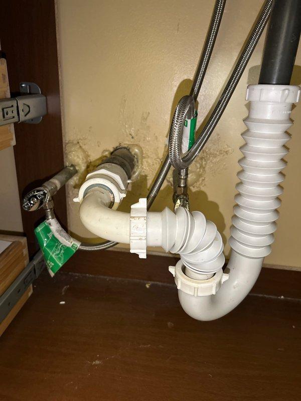 Diagnosed low water pressure issue in bathroom fixture, identifying calcium deposits in supply lines and partial blockage in the drain assembly. Inspected the 50-gallon Rheem water heater in garage utility closet, finding it was functioning properly but noted water damage and possible mold on wall surrounding bathroom plumbing penetrations. Cleaned affected drain components and recommended replacement of corroded supply lines to restore proper water pressure and flow.