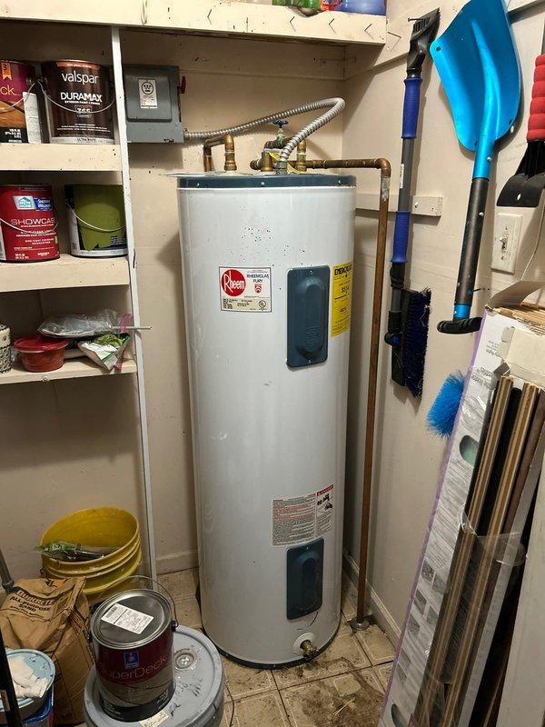 Diagnosed low water pressure issue in bathroom fixture, identifying calcium deposits in supply lines and partial blockage in the drain assembly. Inspected the 50-gallon Rheem water heater in garage utility closet, finding it was functioning properly but noted water damage and possible mold on wall surrounding bathroom plumbing penetrations. Cleaned affected drain components and recommended replacement of corroded supply lines to restore proper water pressure and flow.