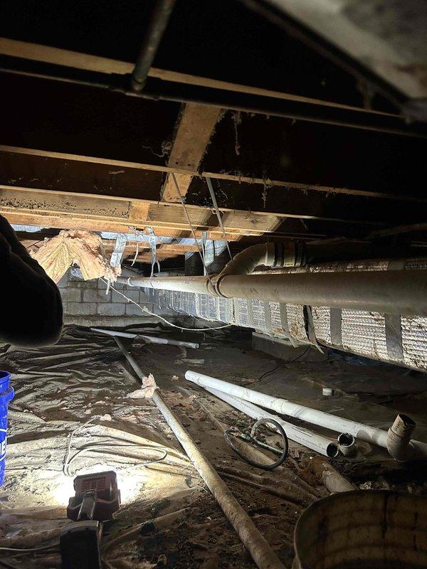 Completed replacement of approximately 20 feet of 2" drain pipe and 2" tee fitting in crawl space that had improper slope causing recurring clogs. Accessed area beneath structure, removed defective piping sections, and installed new PVC drainage components with proper fall to ensure effective waste flow.