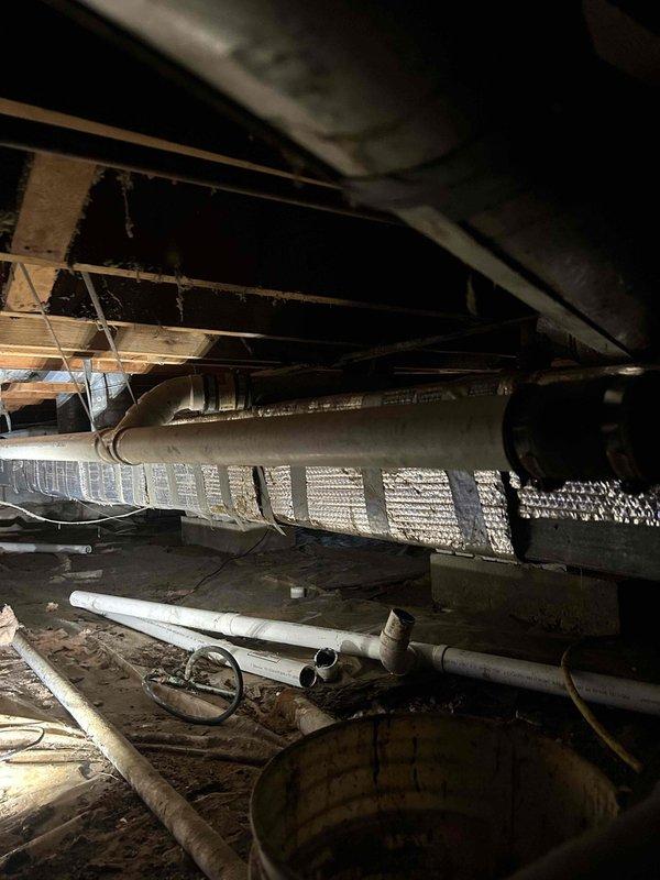 Completed replacement of approximately 20 feet of 2" drain pipe and 2" tee fitting in crawl space that had improper slope causing recurring clogs. Accessed area beneath structure, removed defective piping sections, and installed new PVC drainage components with proper fall to ensure effective waste flow.