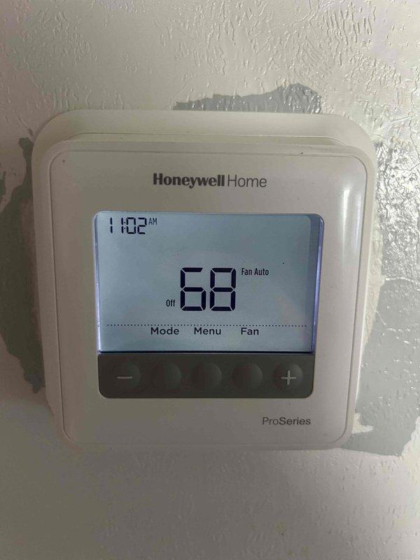 Responded to a no-cooling call for a 5-year-old heat pump system where the indoor blower was operational but the outdoor unit was non-functional. Diagnostic testing revealed indoor temperature at 23.5°C (74.3°F) with the thermostat set to 68°F. Verified Honeywell ProSeries thermostat was properly functioning in cooling mode with "Fan Auto" setting engaged.