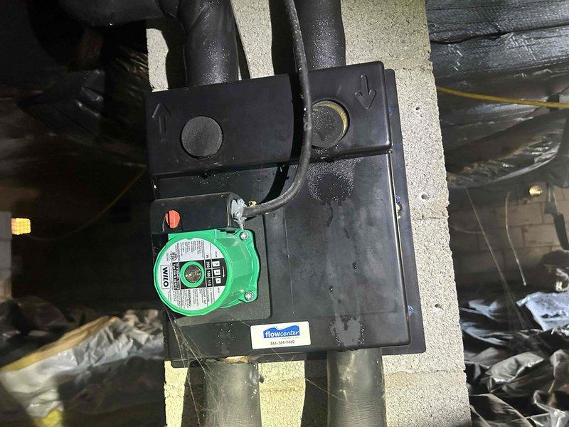 Performed scheduled Care Plan Tune Up on geothermal system located in crawl space. Inspected Wilo circulator pump and flowcenter components for proper operation. Temperature readings confirmed system operating at 48°F, within normal parameters for geothermal loop.