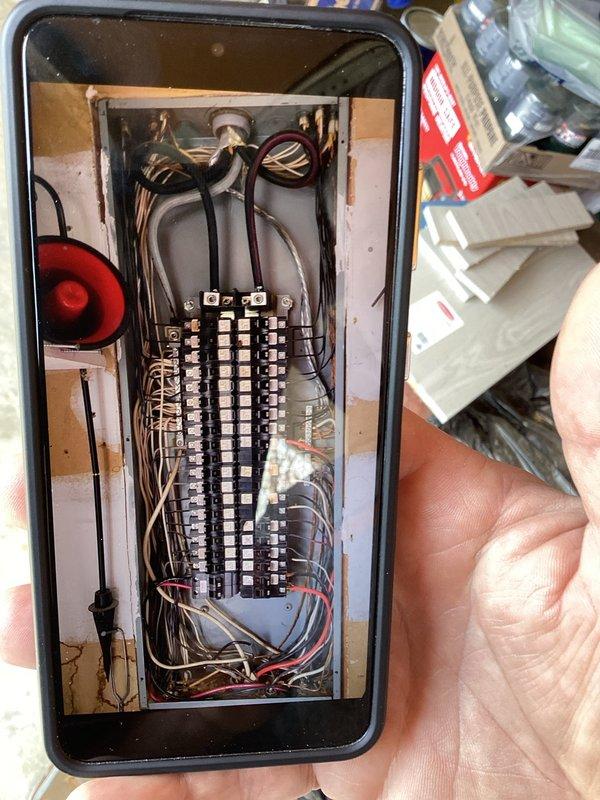 Conducted comprehensive electrical assessment for generator installation, examining the main electrical panel to evaluate capacity and configuration. Inspection revealed complex circuit breaker layout with multiple wire connections that would require proper integration with a transfer switch system for the proposed generator setup.