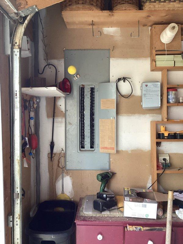 Conducted comprehensive electrical assessment for generator installation, examining the main electrical panel to evaluate capacity and configuration. Inspection revealed complex circuit breaker layout with multiple wire connections that would require proper integration with a transfer switch system for the proposed generator setup.