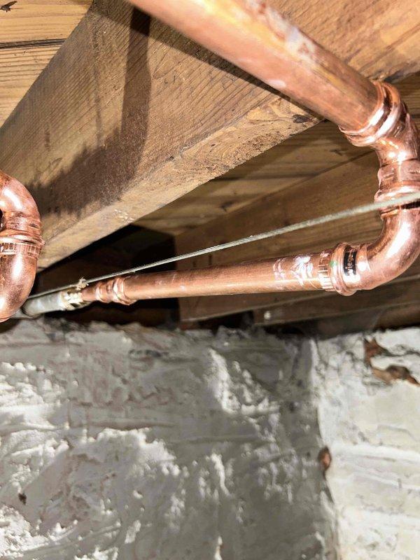 Replaced defective shut-off valve in basement that controlled upstairs faucet. Performed soldering work on copper supply lines and installed new brass fittings to ensure proper water flow control. Tested system for leaks and proper operation after installation.