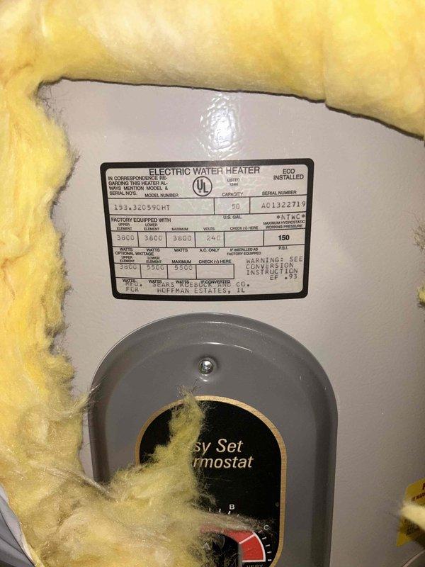 Conducted inspection of existing 50-gallon electric water heater located in basement utility area. Unit shows signs of aging with partial insulation wrap and standard pressure relief valve setup. Documented current installation configuration including electrical connections (240V) and plumbing infrastructure with copper supply lines. Provided estimate options for replacement of equivalent electric tank model versus tankless alternatives.