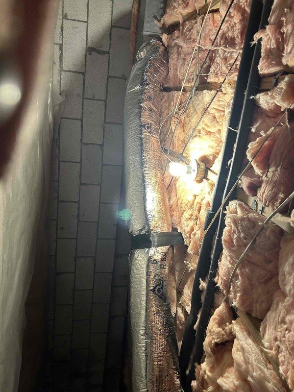 Inspected crawlspace for reported exposed live wire and verified integrity of 6" supply run that was marked for potential replacement. Documented existing insulation configuration and ductwork installation with photos, confirming all electrical components are properly secured and ductwork is correctly insulated with manufacturer-standard reflective metallic insulation tape.