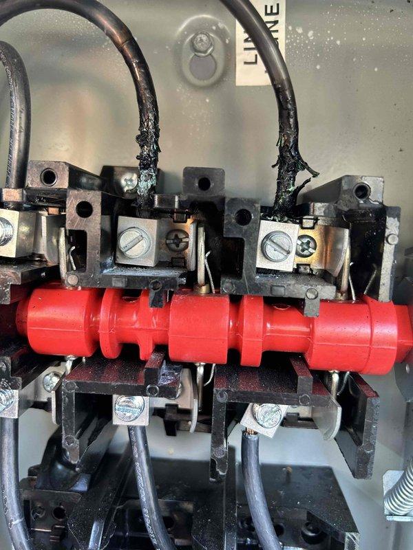 Responded to service call regarding non-functional thermostat on 2nd rooftop unit. Inspection revealed severe electrical damage with burned and frayed wires connected to the terminal bus bar inside the control panel. Observed condensation/moisture throughout the electrical enclosure which likely contributed to the failure. Replaced damaged wiring and terminal connections, then sealed panel properly to prevent future moisture infiltration.