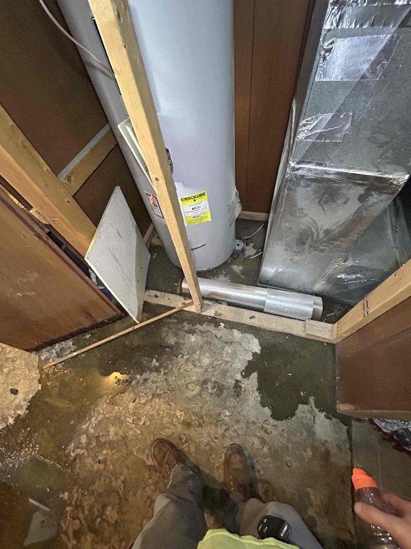 Responded to water leak service call for HVAC unit in basement. Inspection revealed significant moisture damage to surrounding wooden structures with visible rot and black mold formation. Identified water pooling around the water heater and HVAC ductwork area on concrete flooring, causing carpet saturation. Unit is under warranty (less than 1 year old); completed necessary repairs to resolve the leak.