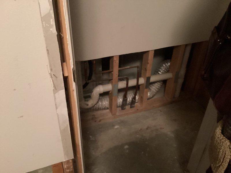 Conducted inspection of exposed wall framing to assess smoke detector wiring system. Replaced battery in hard-wired smoke detector and verified proper function of electrical connections. Observed and documented condition of surrounding electrical infrastructure within wall cavity.