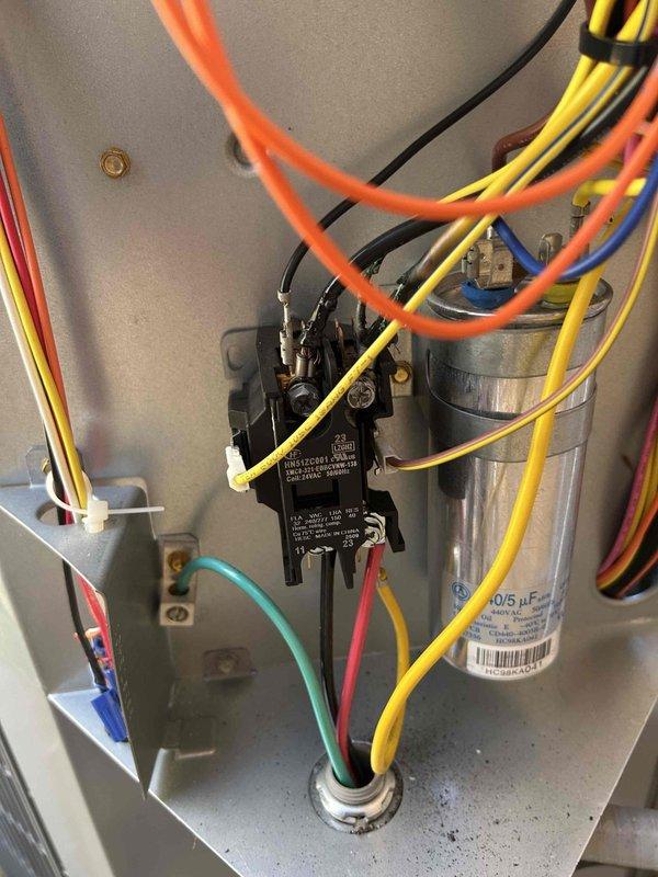 Diagnosed AC system less than one year old that was not cooling or heating after recent maintenance. Visual inspection of electrical control panel showed all components in normal working condition with no visible damage to capacitor (40/5 μF), contactor, or wiring connections. System was restored to proper operation by verifying electrical connections and cycling power to reset the control board.