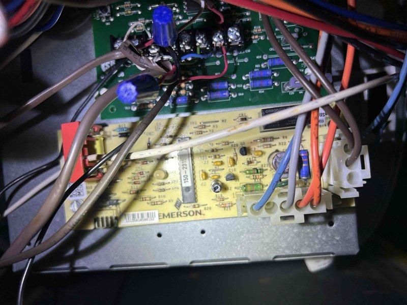 Diagnosed 5-year-old gas HVAC system with no heat issue where unit would activate but not produce warm air. Inspection revealed faulty Emerson control board with visible electronic component failure. Replaced circuit board and verified proper thermostat communication, restoring normal heating function with appropriate temperature response.