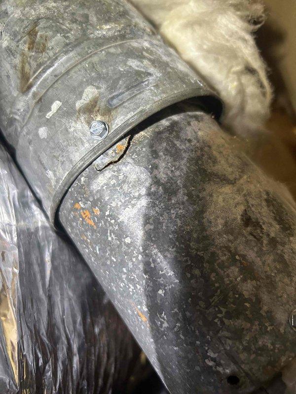 Performed scheduled maintenance tune-up on GF system with attic-mounted AC equipment per Care Plan. Inspected ductwork connections, noting significant dust accumulation and potential insulation deterioration at pipe joints. Conducted electrical diagnostics using Fluke 376 FC clamp meter to verify proper amperage readings. Customer's filter was replaced as part of service.