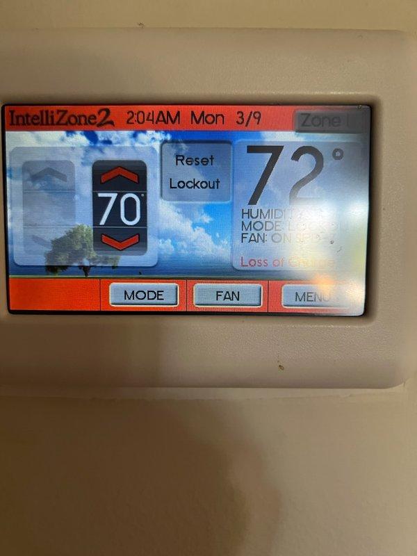 Responded to service call for 26-year-old HVAC system shutting down with E71 error code (loss of charge). Diagnostic inspection of the IntelliZone2 thermostat revealed loss of signal notification and system operating in humidity mode with fan engaged. Examination of the basement air handler unit showed significant age-related wear requiring refrigerant recharge to restore proper functionality.