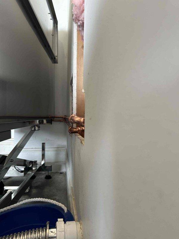 Performed standard maintenance flush on A.O. Smith Signature Premier tanked water heater to remove sediment buildup and maintain optimal performance. Inspected copper piping connections and verified proper operation of temperature controls, with digital display showing normal readings after service completion.