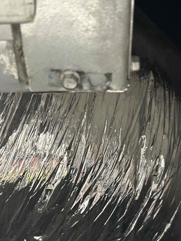 Responded to commercial water leak service call for ceiling-mounted HVAC unit with steady drip. Identified compromised connection between condensate drain line and unit, where rubber coupling showed signs of deterioration. Replaced damaged coupling and verified proper drainage function, eliminating the active leak.