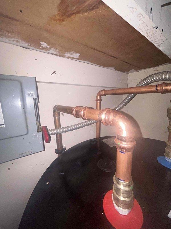 Successfully removed existing galvanized line underneath bathroom faucet and installed new shut-off valve, ensuring proper functionality. Installed customer-supplied Smith 530 water heater with digital control panel, connecting all necessary copper piping and completing electrical connections in the utility area.