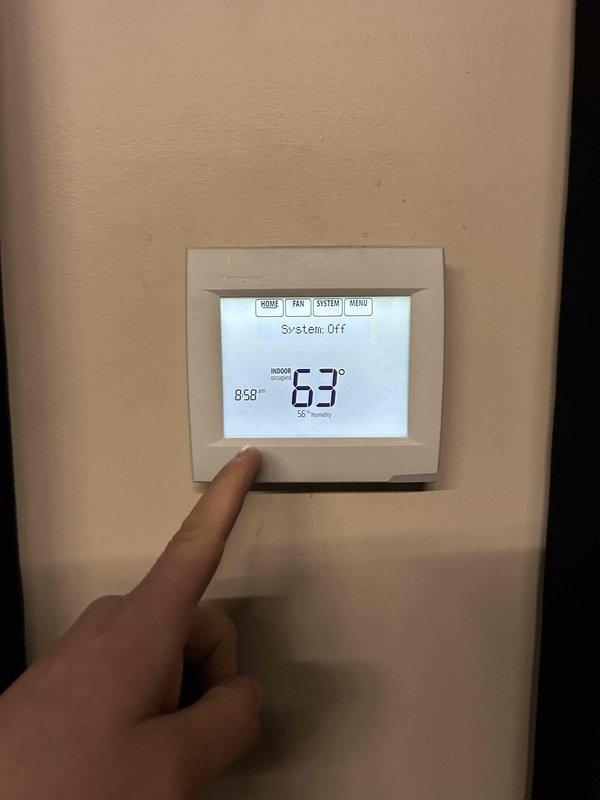 Inspected commercial system reported as not cooling properly in office and sanctuary areas. Found system in OFF mode with thermostat reading 63°F indoor temperature. Examined air filtration system which appeared to be in acceptable condition from previous maintenance visit. Restored proper system operation by correcting thermostat settings and verifying cooling function.