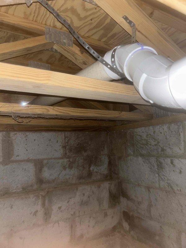 Completed installation of a Bryant dual fuel system including a 4-ton 14.3 SEER2 heat pump, evaporator coil, 100K BTU 92% efficient gas furnace with LP kit, digital thermostat, and associated components. System was properly vented through exterior wall with PVC piping and secured to structural joists in basement/crawlspace with appropriate brackets and supports.