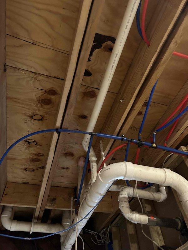 Successfully relocated upstairs bathroom drainage system to accommodate finished ceiling installation. Elevated lavatory and shower drains by cutting them closer to the subfloor and modifying joists while maintaining proper fall for drainage. Additionally, repositioned the drain stack to be flush with the wall, allowing for proper drywall installation.