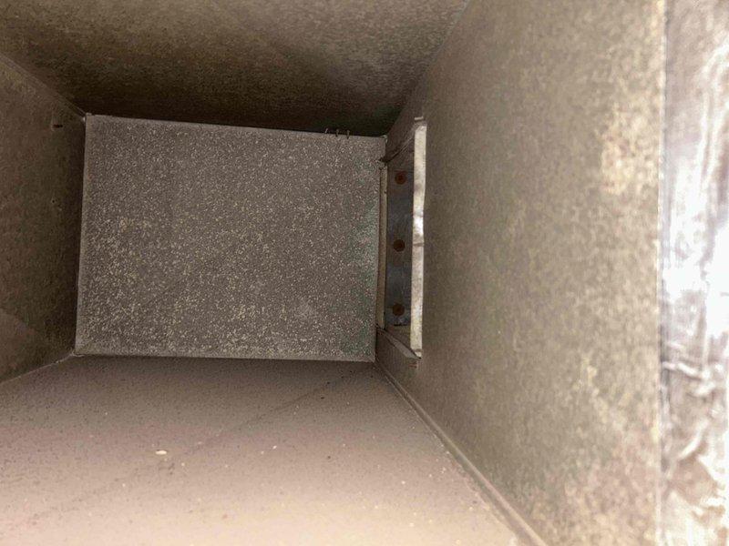 Performed commercial HVAC planned service maintenance on unit requiring 8' ladder access for indoor components above drop ceiling and ground-level access for outdoor components. Inspected ventilation ductwork and damper assembly, and measured electrical current draw of 1.6 Amperes AC using Fluke 376 FC clamp meter. Replaced 21.5" x 13" x 1" air filter as part of routine A/C tune-up service.