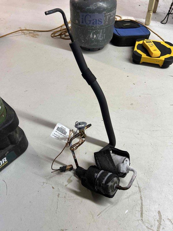 Completed TXV replacement service on HVAC system under PO# 187380175-001. Installed new thermostatic expansion valve and recharged system with 4.5 lbs of refrigerant to restore proper operation. All work documented with photos showing the complete system installation and replacement components.