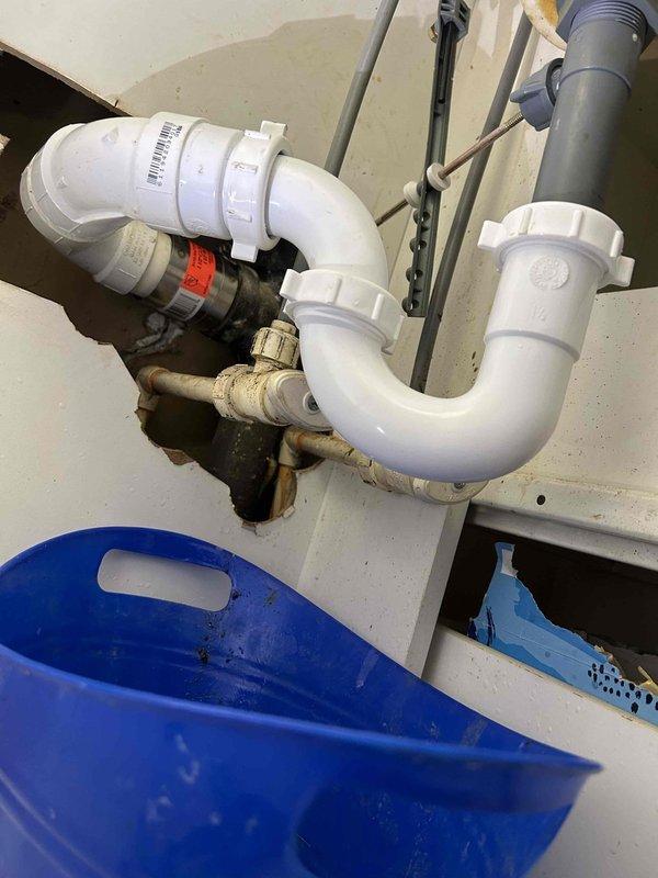 Responded to service call for a clogged right sink in upstairs dual bathroom sink. Inspected the PVC P-trap drain assembly and discovered blockage. Accessed the cleanout point, removed obstruction from the drain line, and verified proper drainage function in both sinks.