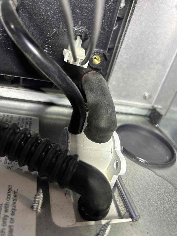 Completed warranty service on heat pump system that was not producing heat despite AUX indicator showing active. Performed diagnostic inspection of drain assembly and electrical connections. Verified proper hose connections and rewired electrical components to restore heating functionality. Customer requires advance notice before arrival and mask wearing due to immunocompromised status.