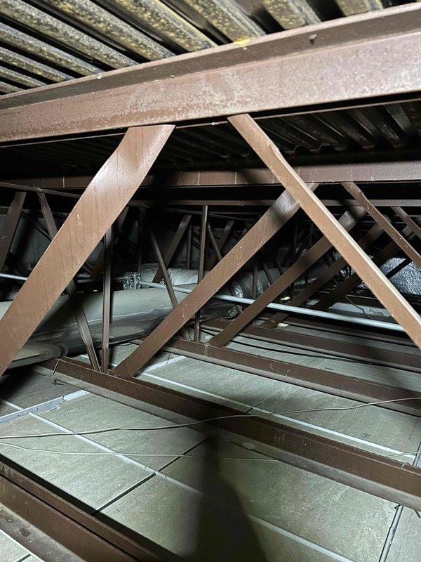 Responded to commercial no-heat complaint where ceiling-mounted radiator units were not heating despite active boiler system. Inspection of attic space revealed loose ductwork connections affecting airflow to designated areas. Reattached and sealed ductwork connections, verified proper heat distribution to all radiator units, and confirmed system operation before completing service.