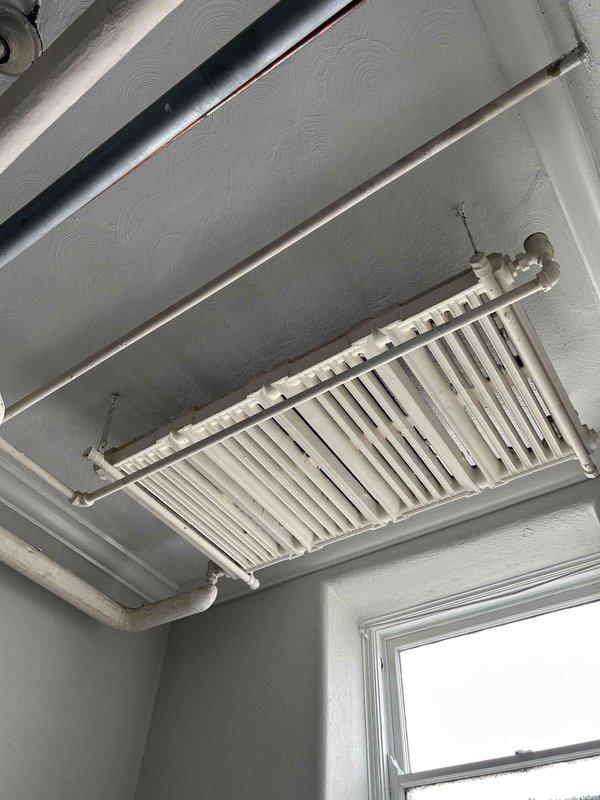 Responded to commercial no-heat complaint where ceiling-mounted radiator units were not heating despite active boiler system. Inspection of attic space revealed loose ductwork connections affecting airflow to designated areas. Reattached and sealed ductwork connections, verified proper heat distribution to all radiator units, and confirmed system operation before completing service.