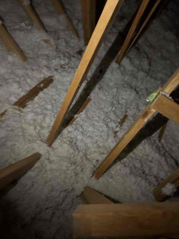 Installed supplementary blow-in insulation to address insufficient coverage in attic space. Identified and filled bare spots with one bag of insulation material to improve thermal efficiency. Documented installation with before and after photos for home inspector verification.