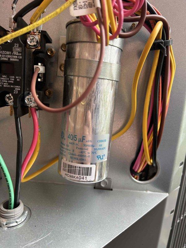 Performed annual care plan tune-up on Bryant heat pump/air handler system located in closet. Conducted electrical diagnostic testing with clamp meter, verifying proper voltage readings (123V) and inspected 40/5 μF capacitor and associated wiring connections. All components were found to be in good working condition with no visible damage or wear.