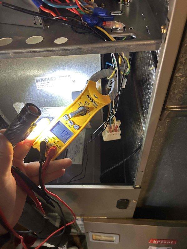 Performed annual care plan tune-up on Bryant heat pump/air handler system located in closet. Conducted electrical diagnostic testing with clamp meter, verifying proper voltage readings (123V) and inspected 40/5 μF capacitor and associated wiring connections. All components were found to be in good working condition with no visible damage or wear.