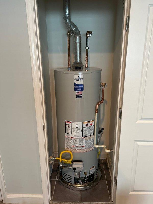 Successfully installed a new Bradford White Basic 50-gallon gas water heater with 6-year tank/parts warranty and 1-year labor warranty in utility closet. Connected to existing water lines, gas supply, and vent system with all necessary piping and fittings, ensuring proper combustion as verified by flame test. Removed and disposed of old unit and secured required KY Division of Plumbing permit and inspection.