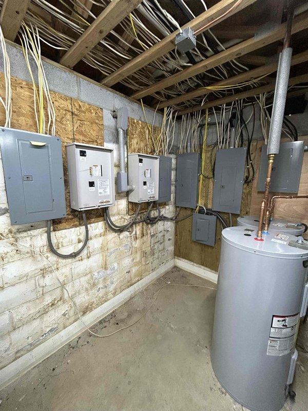 Performed diagnostic service on 45KW liquid-cooled Generac generator (Serial #4690426). Multiple fault codes were detected during inspection. Advised against attempting to start the unit due to numerous active error codes. Documented electrical panel configuration and generator integration with the building's electrical system.