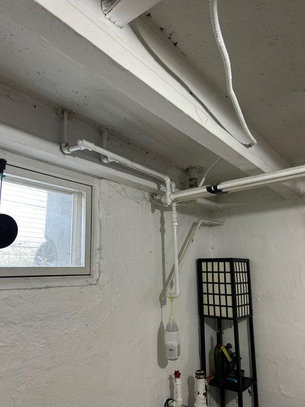 Responded to service call for clogged sink. Inspected basement plumbing system with PVC drainage pipes and under-sink P-trap configuration. Successfully cleared blockage and verified proper drainage function, ensuring system returned to normal working condition.