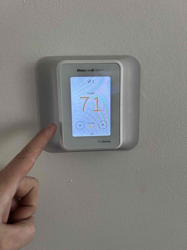 Performed Care Plan Tune Up on heat pump/air handler system installed in 2024. Conducted electrical diagnostics with clamp meter confirming 148V reading at control panel. Verified proper operation of Honeywell Home Pro Series smart thermostat (71° current/69° set point) and noted weak Wi-Fi signal (1 bar) with 32% battery level. Customer will provide 20x20x1 filters for future maintenance.
