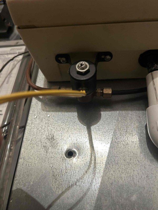 Responded to callback regarding continuous air handler operation and non-functioning humidifier despite thermostat indication. Inspected Aprilaire Model 560 whole-house humidifier and discovered water flow issues in the condensate drainage system. Cleaned drainage components, verified proper water flow through the humidifier, and confirmed system is now operating according to specifications.