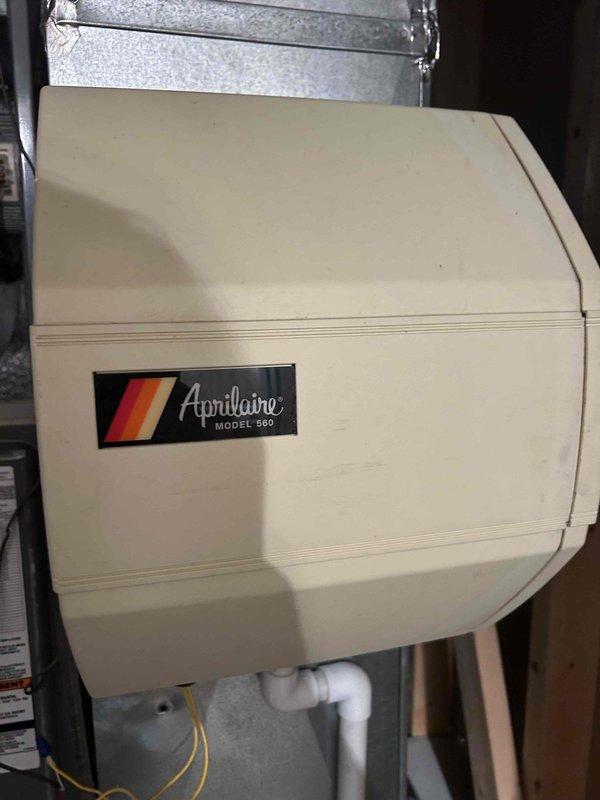 Responded to callback regarding continuous air handler operation and non-functioning humidifier despite thermostat indication. Inspected Aprilaire Model 560 whole-house humidifier and discovered water flow issues in the condensate drainage system. Cleaned drainage components, verified proper water flow through the humidifier, and confirmed system is now operating according to specifications.