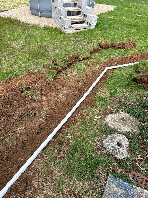 Successfully removed existing sump pump from sewer line and relocated approximately 30ft away from the residence. Excavated trenches in yard, installed PVC discharge pipe with proper drainage materials, and positioned pump to direct water flow away from foundation as requested.